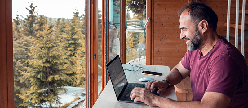 Man working from vacation home in the mountains.