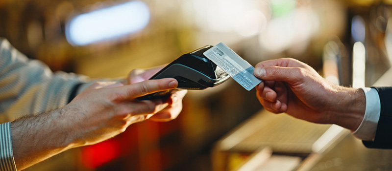 Man pays for goods with a credit card.