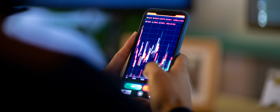 Person reviewing investment performance on smartphone.