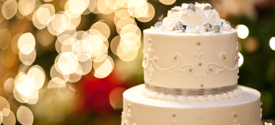 Close-up of a wedding cake with lights in the background