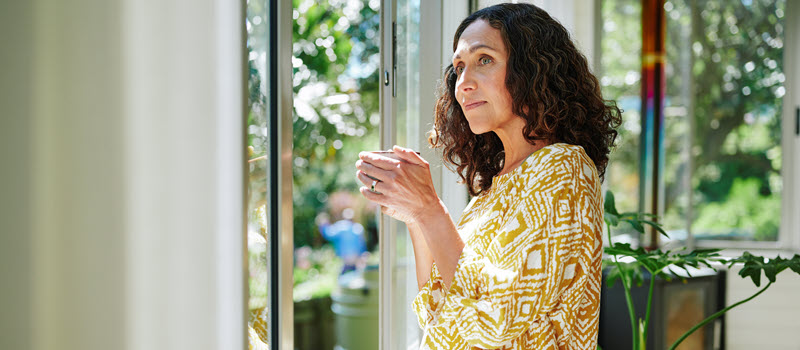 Woman looking out window.