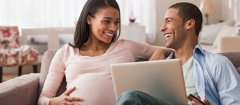 Young expecting couple reviews finances in advance of the birth of a child.