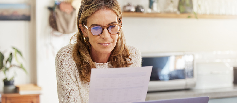 Mature woman reviewing finances at home.